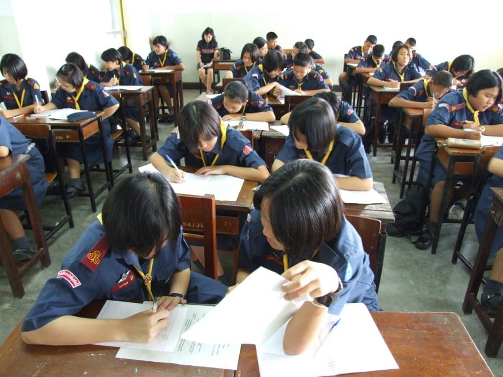 A class of students working at their desks in a school in Asia.