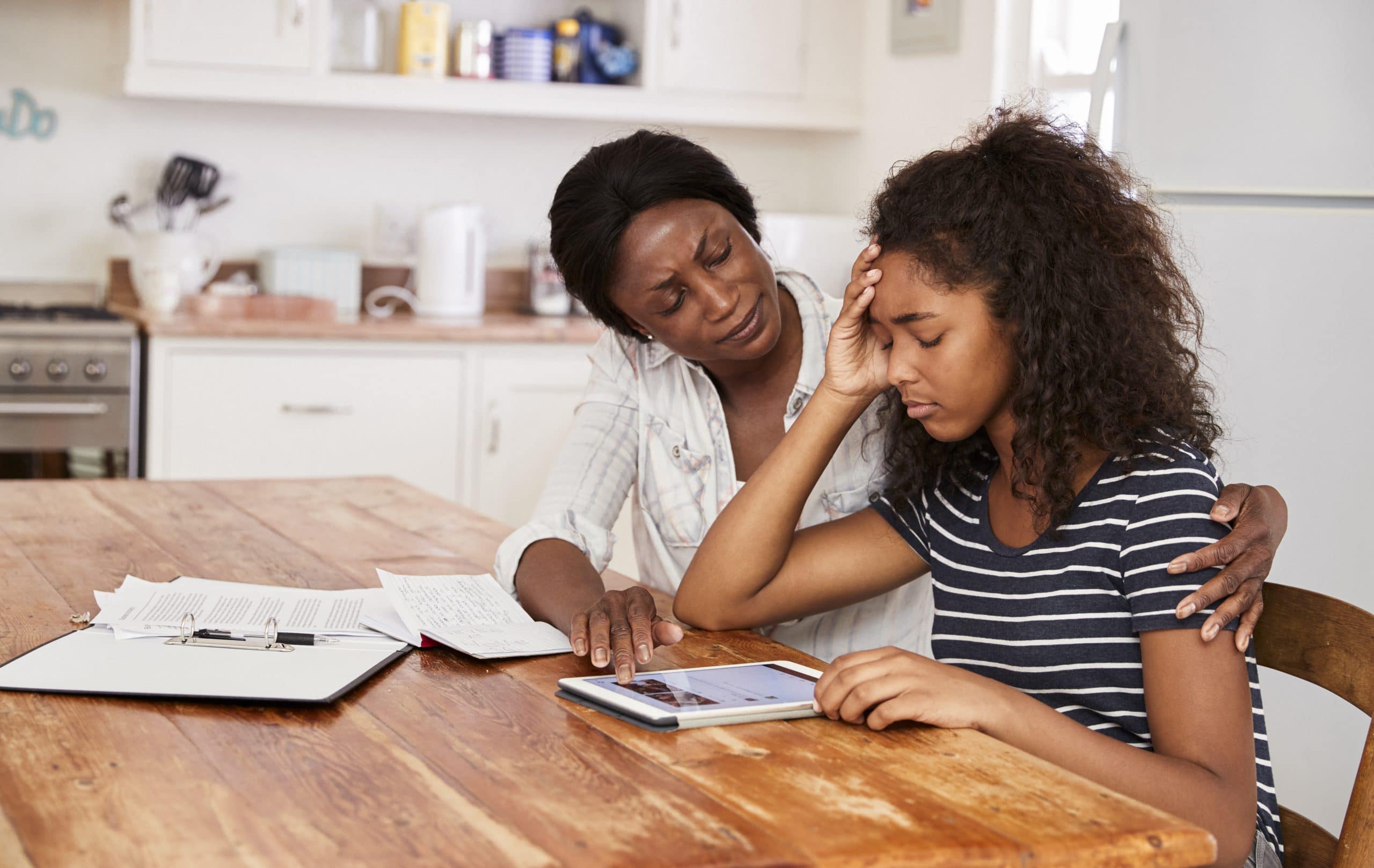 A mother helping her stressed-out teenage daughter revise.