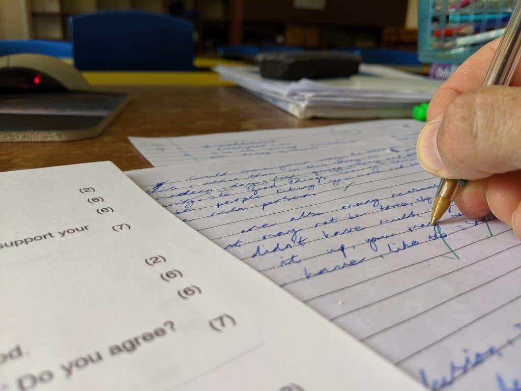 A teacher marking a student's piece work.