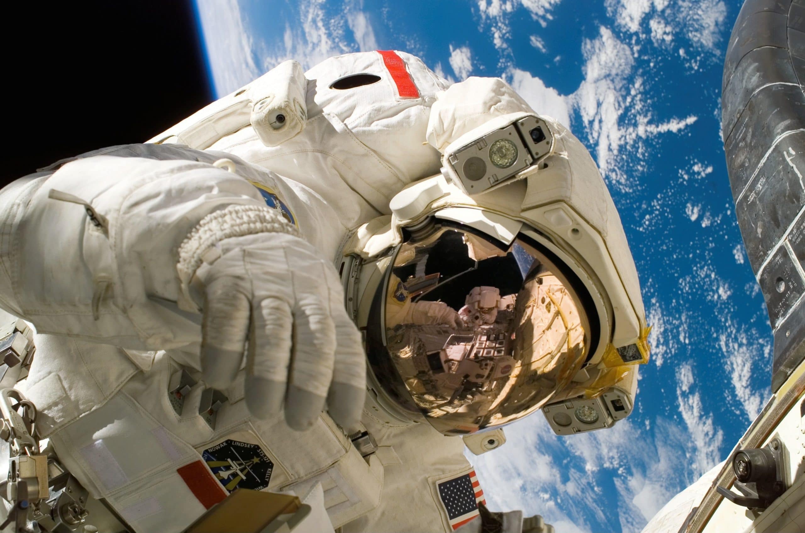 An astronaut in space with Earth visible in the background.