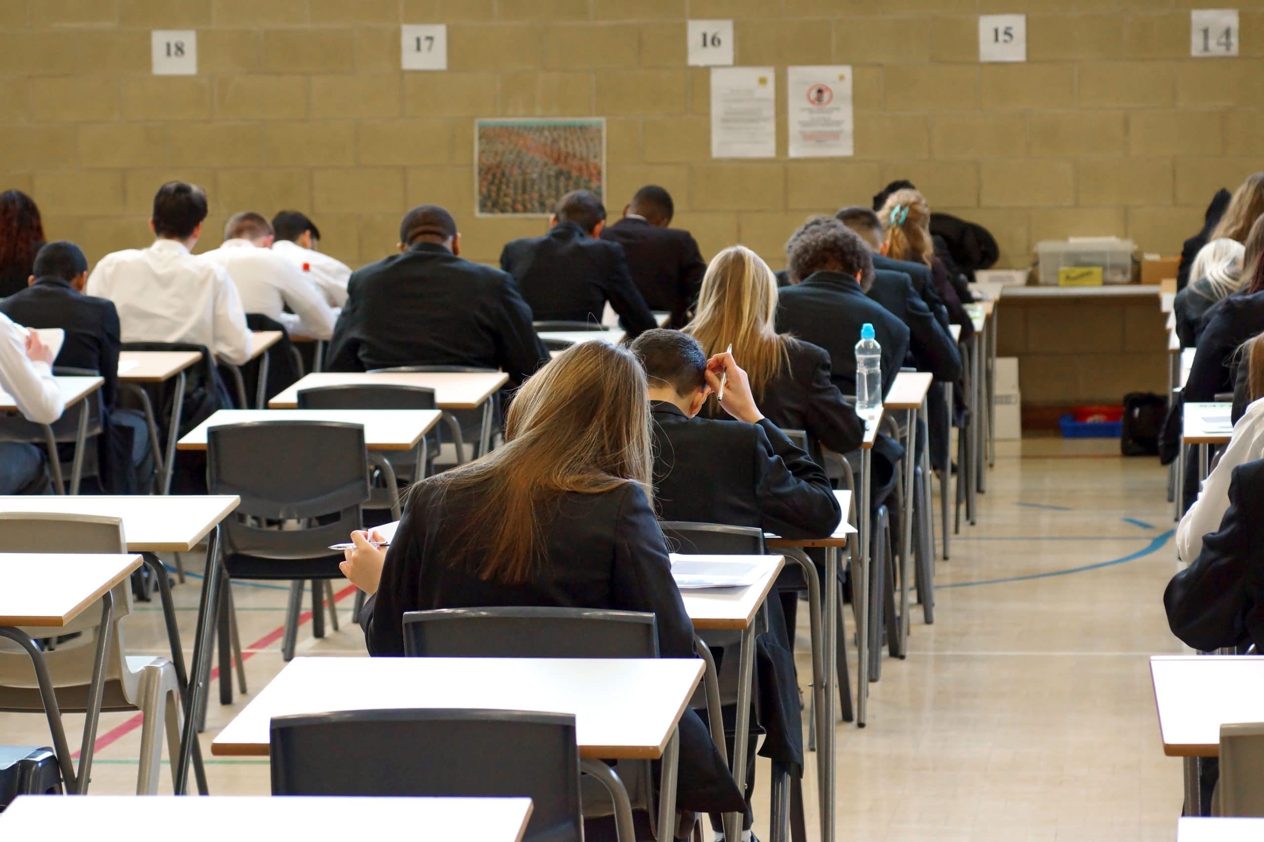 Students sitting in an exam hall.
