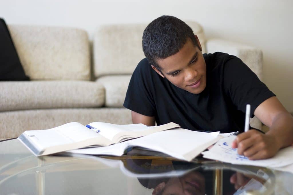 A teenage boy doing his homework.