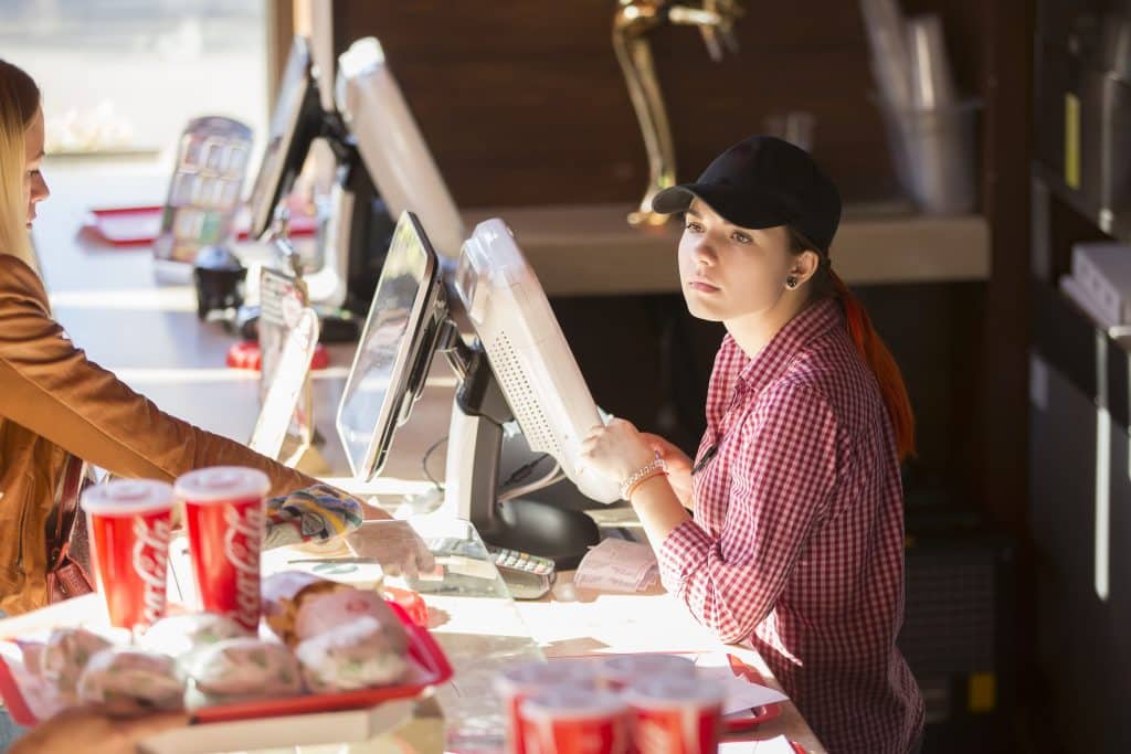 A student working part-time in a fast food restaurant.